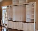 Custom Entertainment Center with book shelves and a rolling ladder